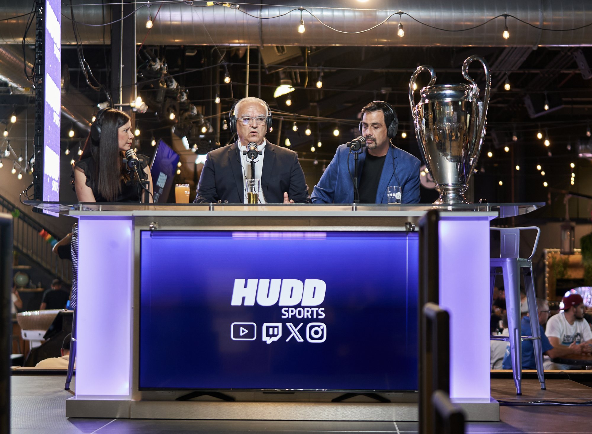 Hudd Sports hosts and guests at a soccer broadcast desk