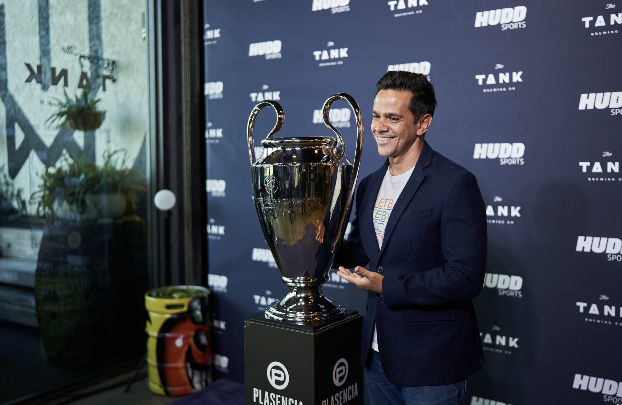 Hudd Sports guest beside the Champions League trophy