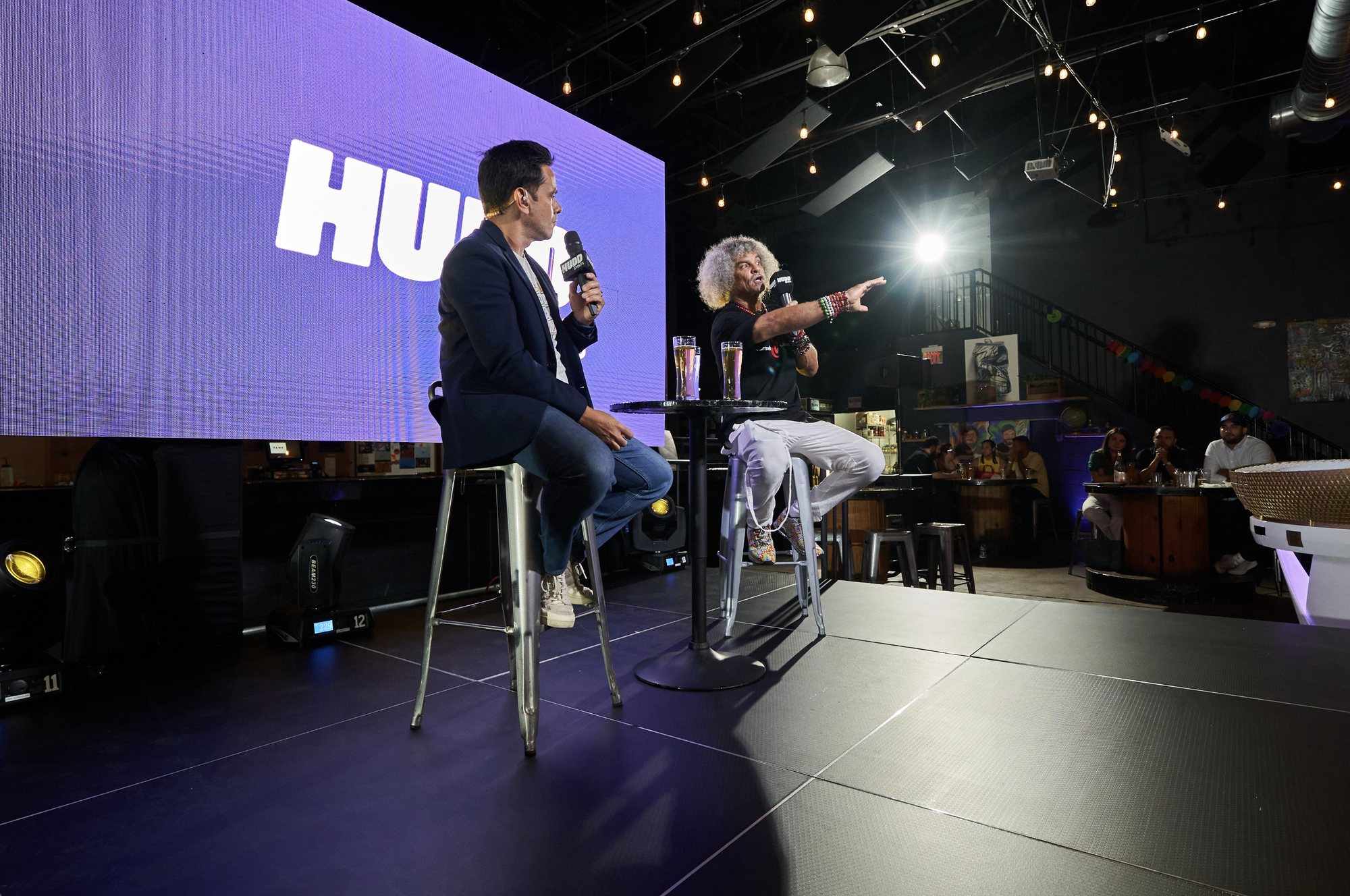 Hudd Sports host in conversation with a guest on stage